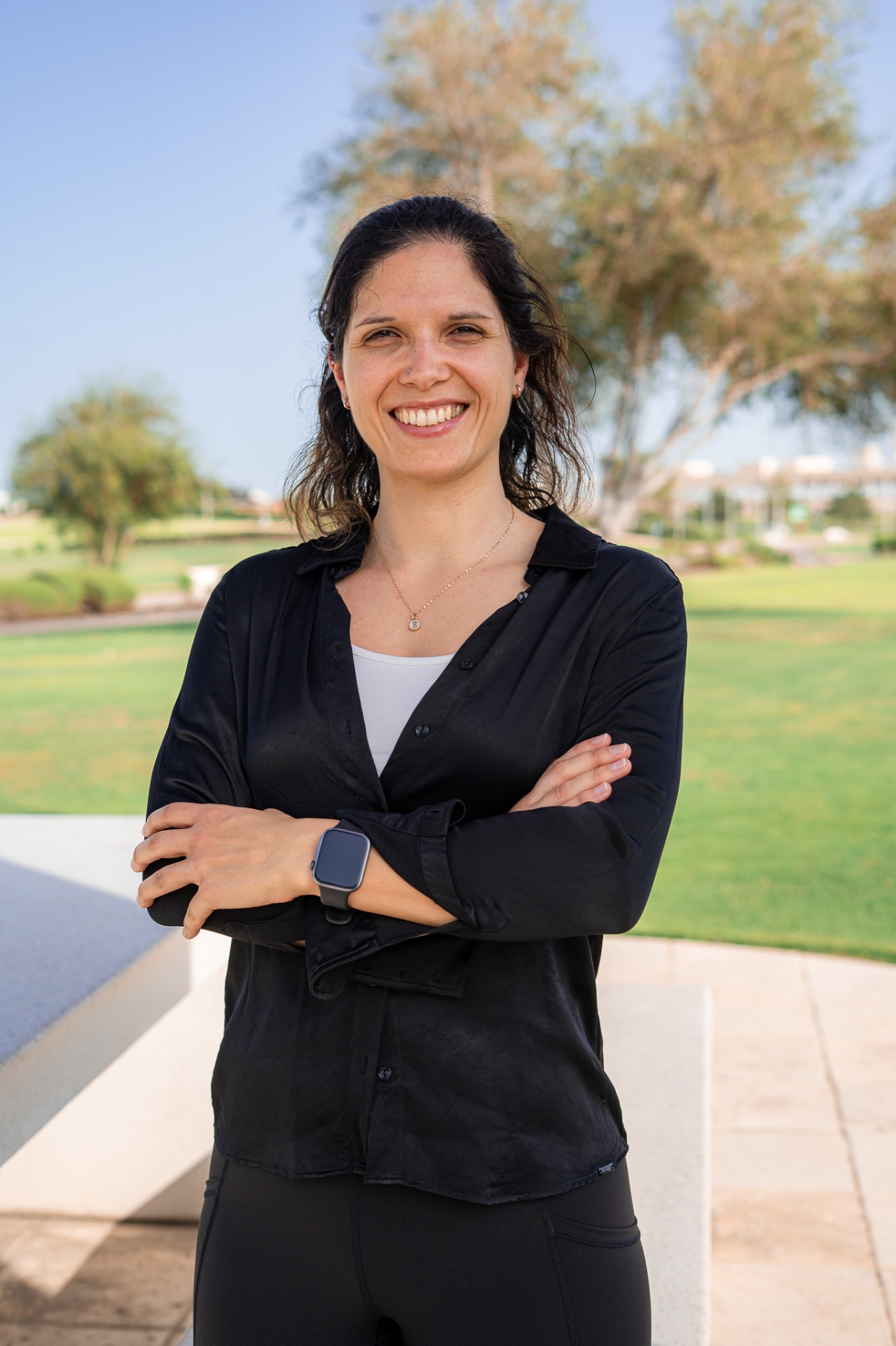 Raquel Madeira, founder of Reshape, standing outdoors with crossed arms